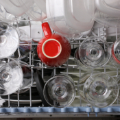 An open dishwasher full of clean dishes.