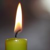 A green candle that is burning.