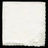 White linen napkin with embroidered corner.