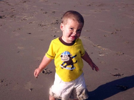 Boy with Yellow Shirt and Sand on His Face