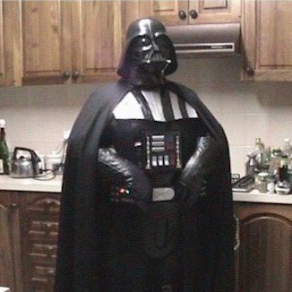 Man Standing in Kitchen in Darth Vader Costume