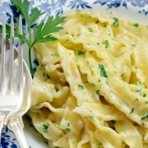 Fettuccine Alfredo on a blue and white plate.