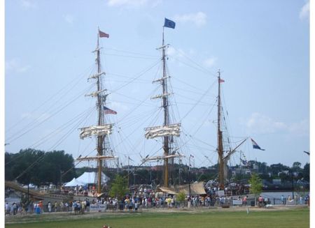 Large Wooden Sailing Ship With People in Foreground