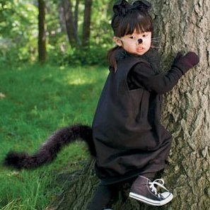 Little girl in a black cat costume.