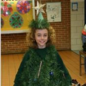 Young girl in a Christmas tree costume.