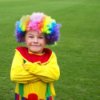 Child in a brightly colored clown costume.