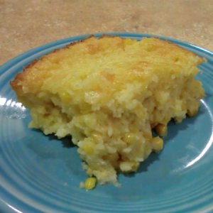 Corn spoon bread on a blue plate.