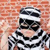 Boy Behind Fence in Convict Costume