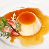 Panna cotta with caramel sauce and fresh strawberries.