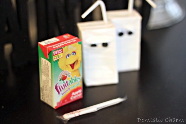 Three juice boxes, two decorated as mummies and one unadorned.