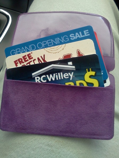Purple pill pouch with gift cards inside.