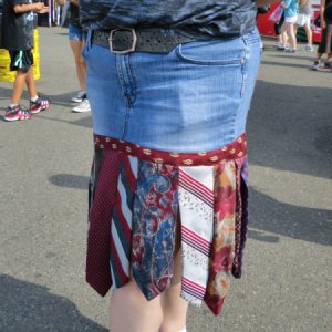 Upclose photo of necktie and denim skirt.