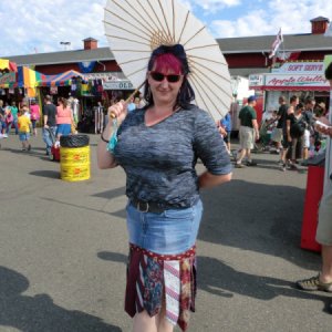 Woman wearing a neck tie and denim skirt.