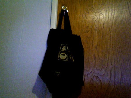 Book bag hanging on the knob on back of door.