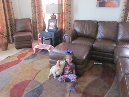 Sugar the Dog sitting on Floor With Little Girl