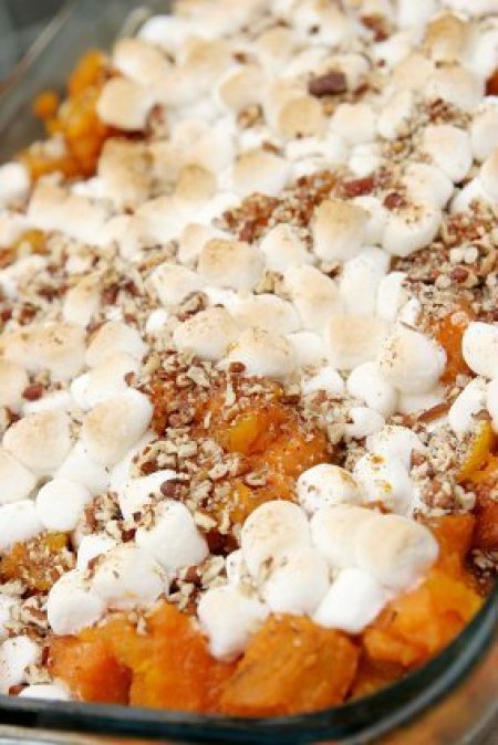 A traditional sweet potato casserole topped with marshmallows.