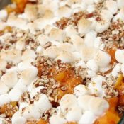 A traditional sweet potato casserole topped with marshmallows.