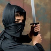 Young boy dressed in a ninja costume.