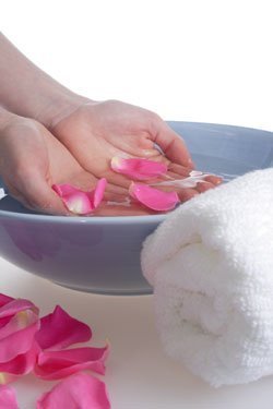 A bowl of rose petals for soaking hands or feet.