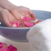 A bowl of rose petals for soaking hands or feet.