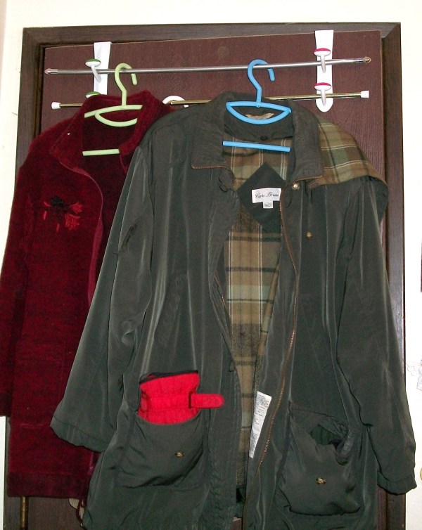 Two jackets hanging from unit.