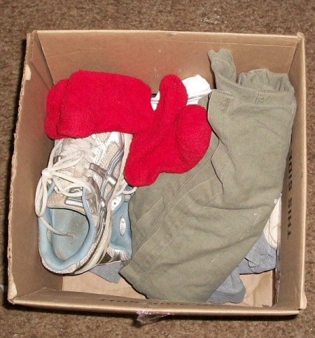 Emergency clothing and shoes in cardboard box.