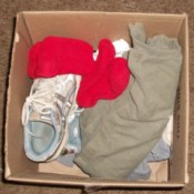 Emergency clothing and shoes in cardboard box.