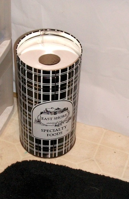 Decorative tin used for extra TP storage.