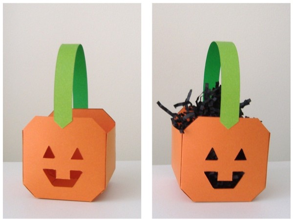 Two pumpkin baskets, side by side, one onthe right has black filler in it.