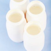 Plastic bottles of white drinkable yogurt.