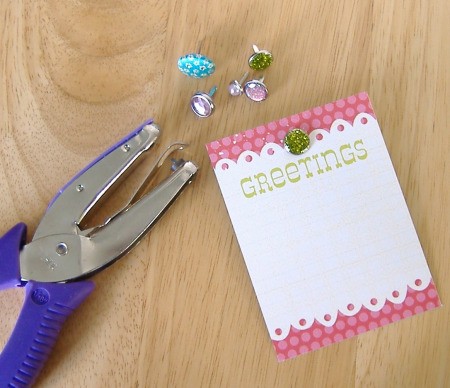 Hole punch, small card, and decorative brads.