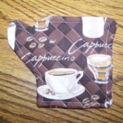 Coffee cup coaster in the shape of a coffee pot.