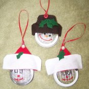 Christmas ornaments made from jar rings. There are two Santas and snowman ornament.