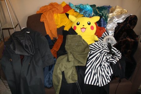 Clothes Piled on a Couch After Shopping Trip