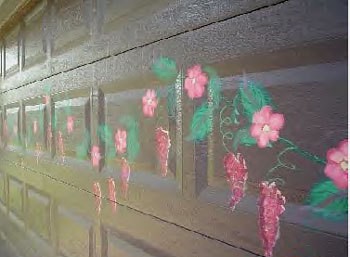 Flowers painted on a garage door.