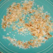 Toasted coconut on a blue plate.