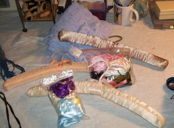 Padded silk hangers with bags of different colored satin ribbons.
