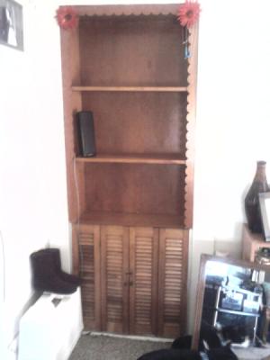 Built-in shelf unit with three shelves and lower doors.