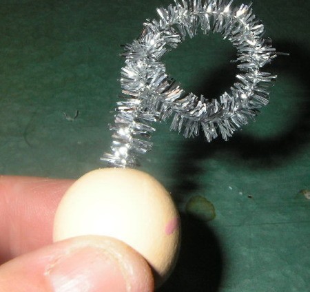 Attaching chenille halo to bead head.