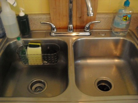 Bathtup basket attached to back of stainless steel kitchen sink