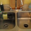 Bathtup basket attached to back of stainless steel kitchen sink