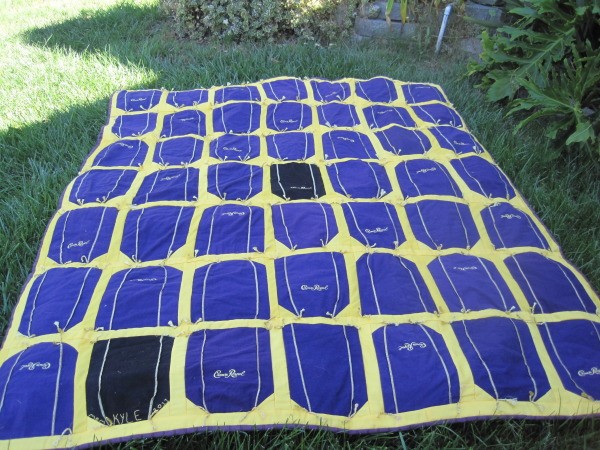 Crown Royal quilt lying on the lawn.