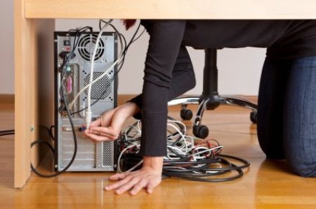 Photo of the wires behind a computer desk.