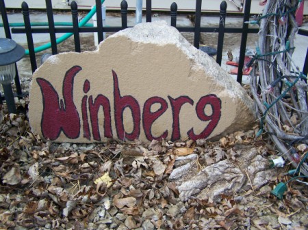 Cement piece with name painted on.