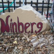 Cement piece with name painted on.