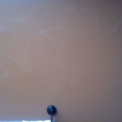 Faint lighter lines on wall.