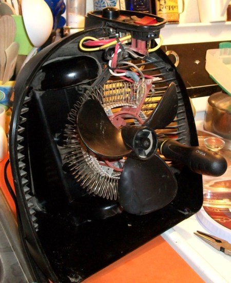 Disassembled heater with socket handle visible.