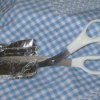 Picture of sharpening scissors with aluminum foil.