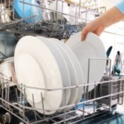 Someone loading dishes into a dishwasher.