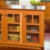 Bungalow style kitchen cabinet with glass paned doors.